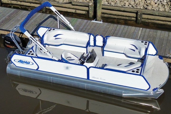 Pontoon boat docked with blue and white seating, viewed from above.